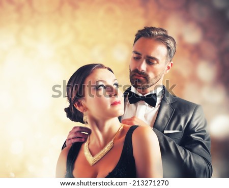 A man gives a necklace to his wife