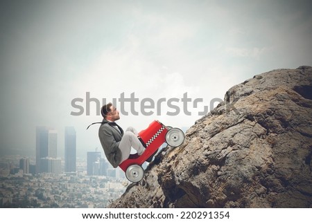 Businessman driving a fast car in a mountain