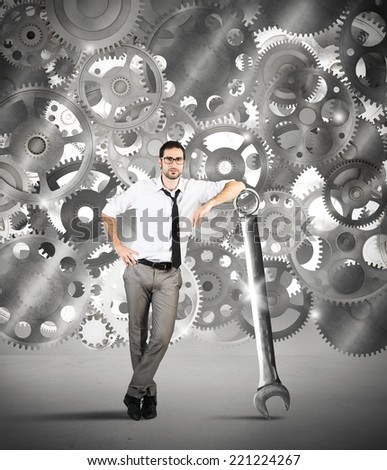 Businessman makes maintenance of a system of gears