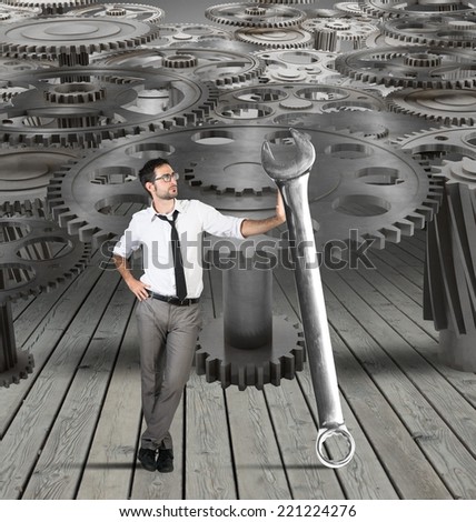 Businessman makes maintenance of a system of gears