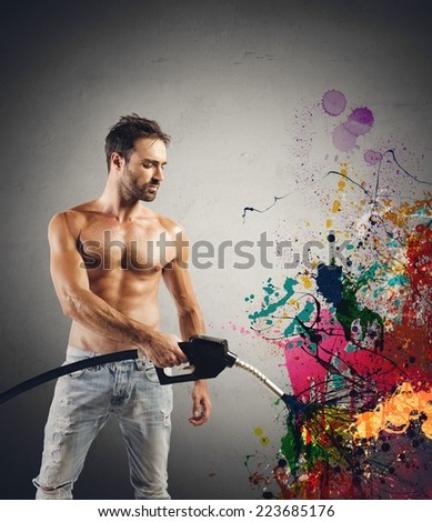 Sexy man with fuel pump and colorful effect