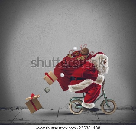 Santaclaus delivering gifts with a small bicycle