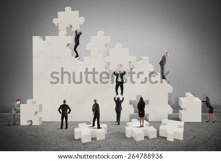 Business team working to build a puzzle