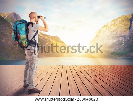Explorer observes a lake in the mountains