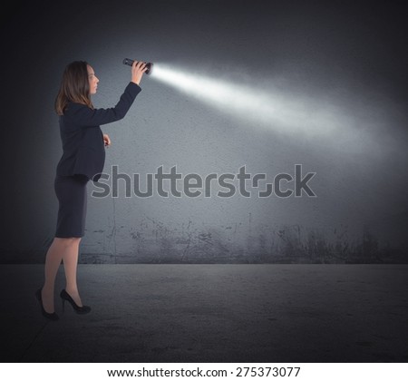 Businesswoman with a torch lights to search