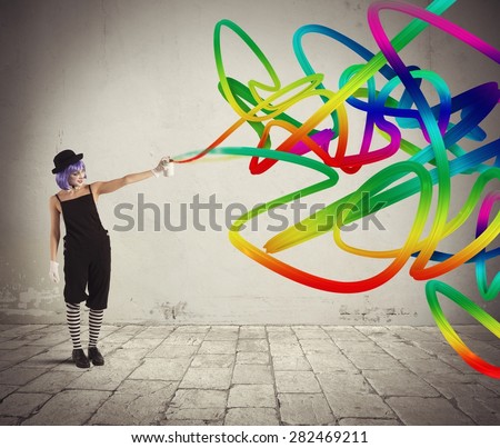 Woman clown with colored spray paints trails