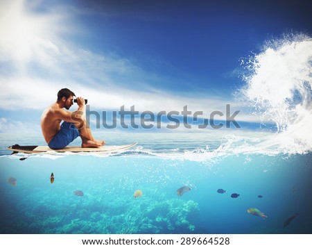 Surfer looking for the wave whit binoculars