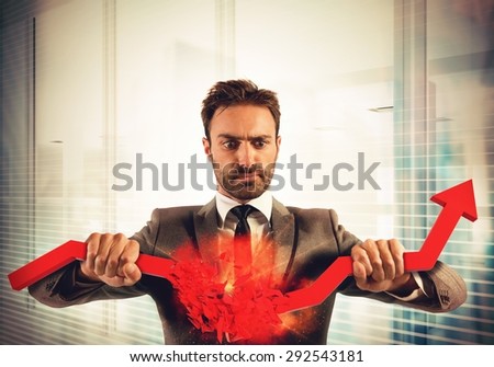 Angry businessman breaks a big red arrow