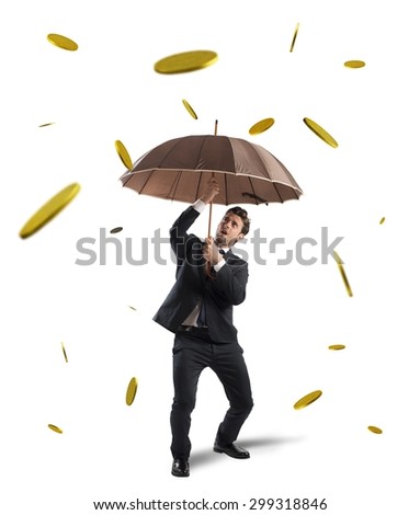 Businessman is protected by a money rain