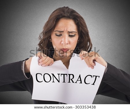 Annoyed businesswoman tears the document work contract