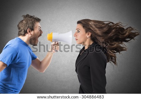 Man shouting with megaphone to a businesswoman