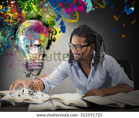 Man reads books with above colored bulb