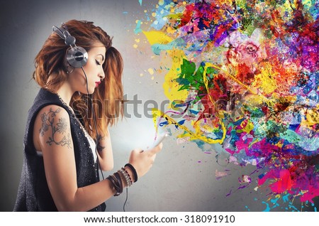 Tattoo girl listens to music with headphones