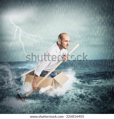 Businessman surfs on a cardboard during storm