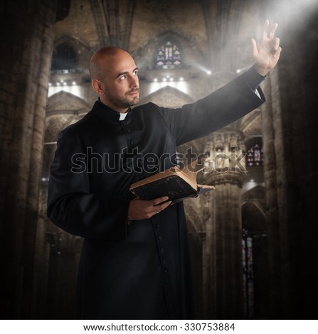 Priest prays in the church with bible