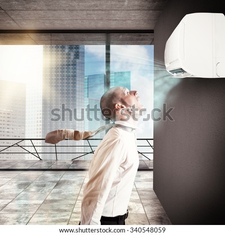 Businessman frozen by the air conditioner power