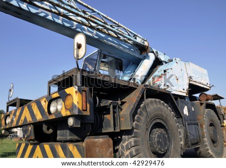 A crane mounted on an undercarriage with four rubber tires for off-road and 