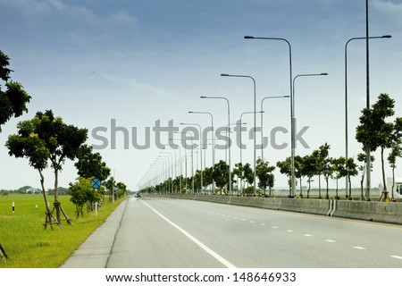 Road line of the against blue sky and white cloud , Beautiful roads, street light poles, light