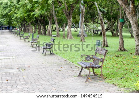 Many chairs in the park , Autumnal park with bench and leaves