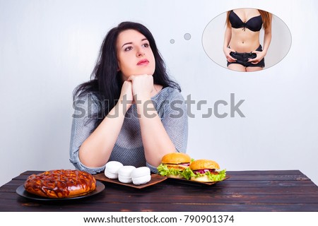 Overweight obese woman with junk food dreaming of fit and slim body. Weight losing, obesity, high-calorie food, unhealthy nutrition,dieting concept