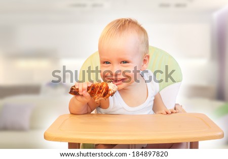Hungry little  boy eat chicken. Yummy but harmful
