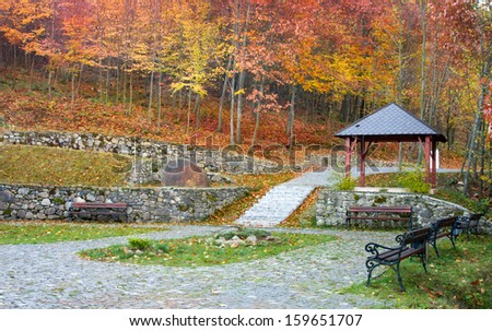 Autumn park landscape. Square to relax in the gazebo and benches