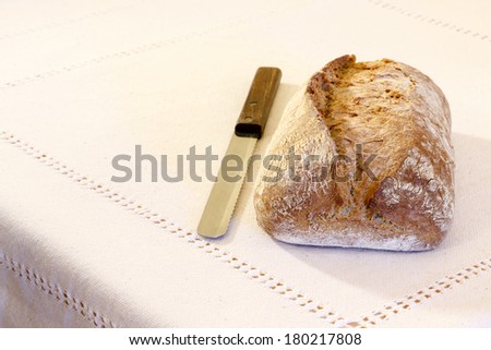 Brown Bread with knife on kitchen board./ Brown Bread
