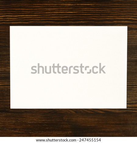 Paper card on wooden desk/ Paper card on wooden desk
