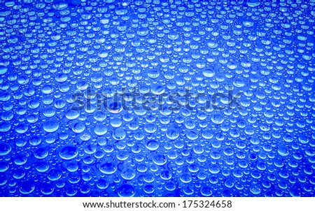 Water drop on glass background.