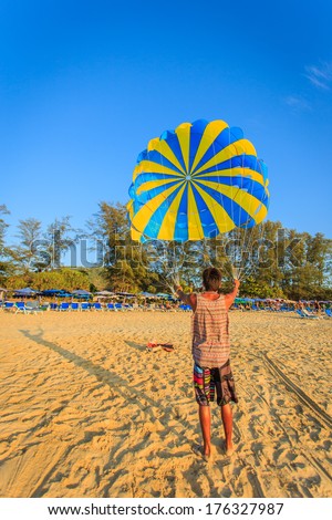 Man is preparing para sailing at the beach in Thailand