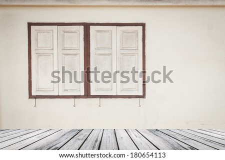 Wood decking with old windows on white wall background