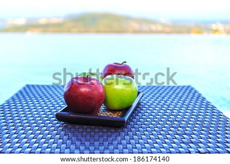 Apples on side table at the pool