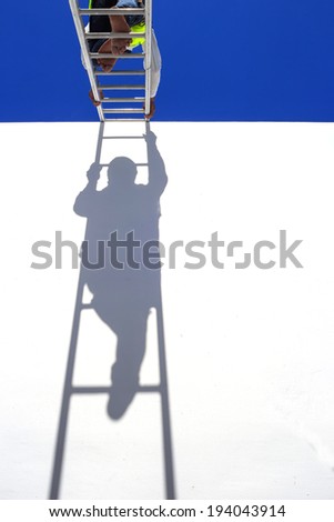Thai man climbing on ladder for work