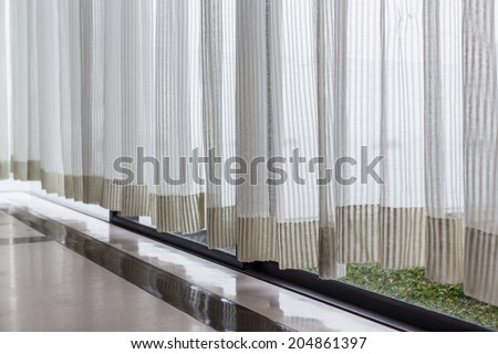 White curtain beside window