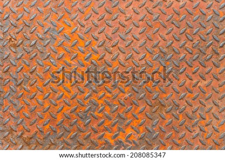 Background of metal diamond plate in red color with rusty