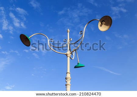 Vintage outdoor lamp on blue sky background
