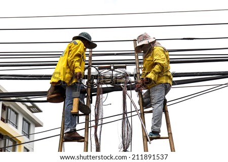 worker on bamboo ladder is repairing telephone line isolated on white