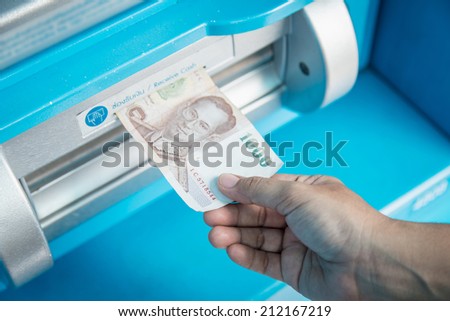 Close up of hand take money from ATM/bank machine