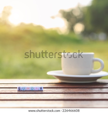 Sunday written in letter beads and a coffee cup on table