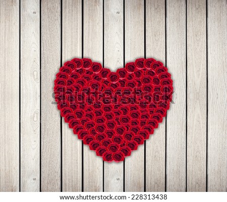 Heart Frame from red rose on wood