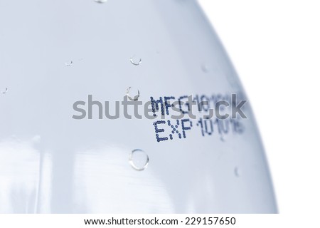 Close up expiration date on plastic bottle isolated on white background