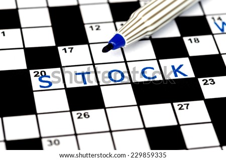 Stock in solving crossword puzzle, close up