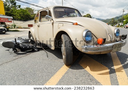 PHUKET, THAILAND - DECEMBER 17 : Car accident on the road and crashed with motorcycle which causing the rider serious injury. December 17, 2014 in Phuket Thailand.