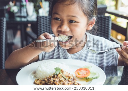 Close up Thai children eating in restaurant