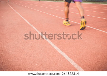 Close up Running track with blur of runner feet in stadium