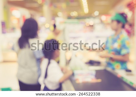 Supermarket store blur background ,Cashier counter with customer, Vintage filter effect