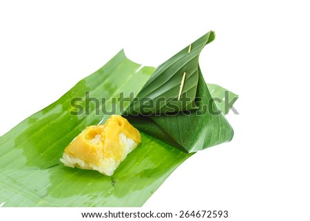 Sticky rice with steamed custard, wrapped in banana leaves isolated on white background