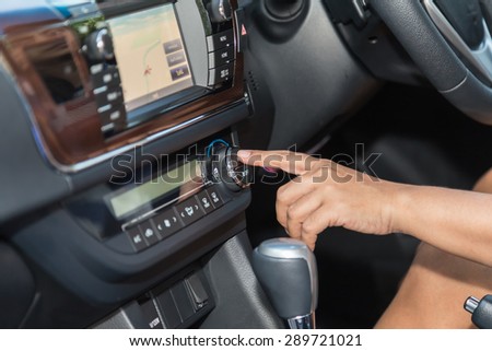 Close up driver hand press air-con button in the car