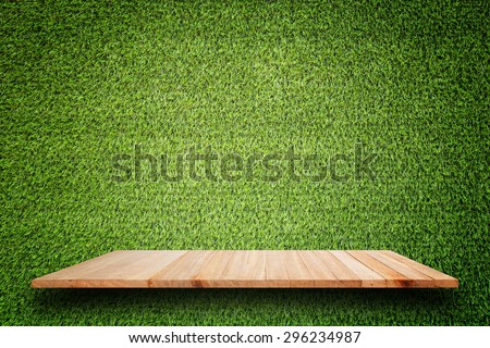 Empty top of wooden shelves and green pattern wall background. For product display