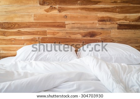 Close up white bedding sheets and pillow, Messy bed concept